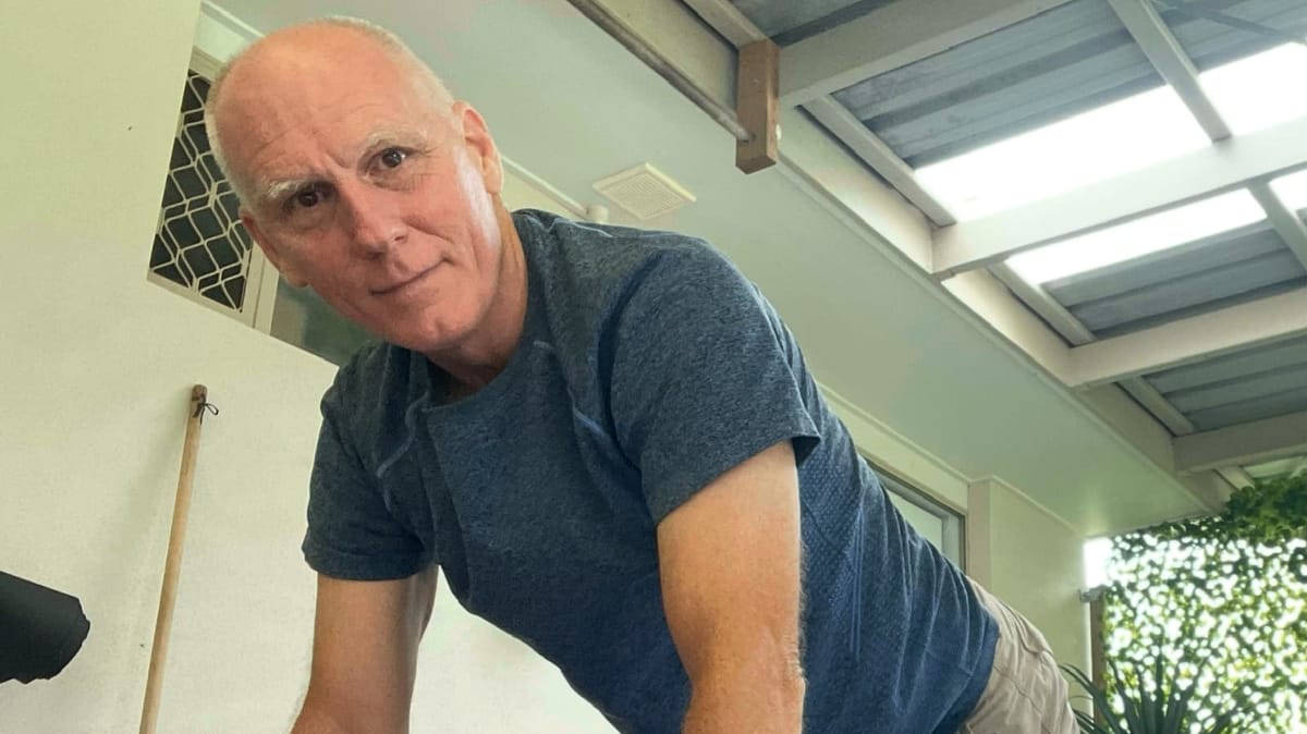 Rob in a pushup stance, early morning, on the back patio.