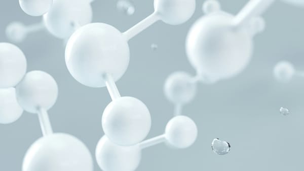 White spheres with rods connecting them on a grey background.