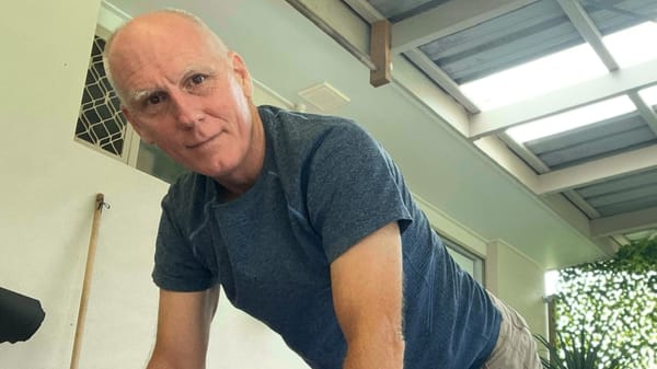 Rob in a pushup stance, early morning, on the back patio.